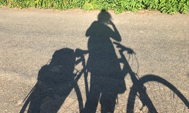 Shadow of a person and their bike